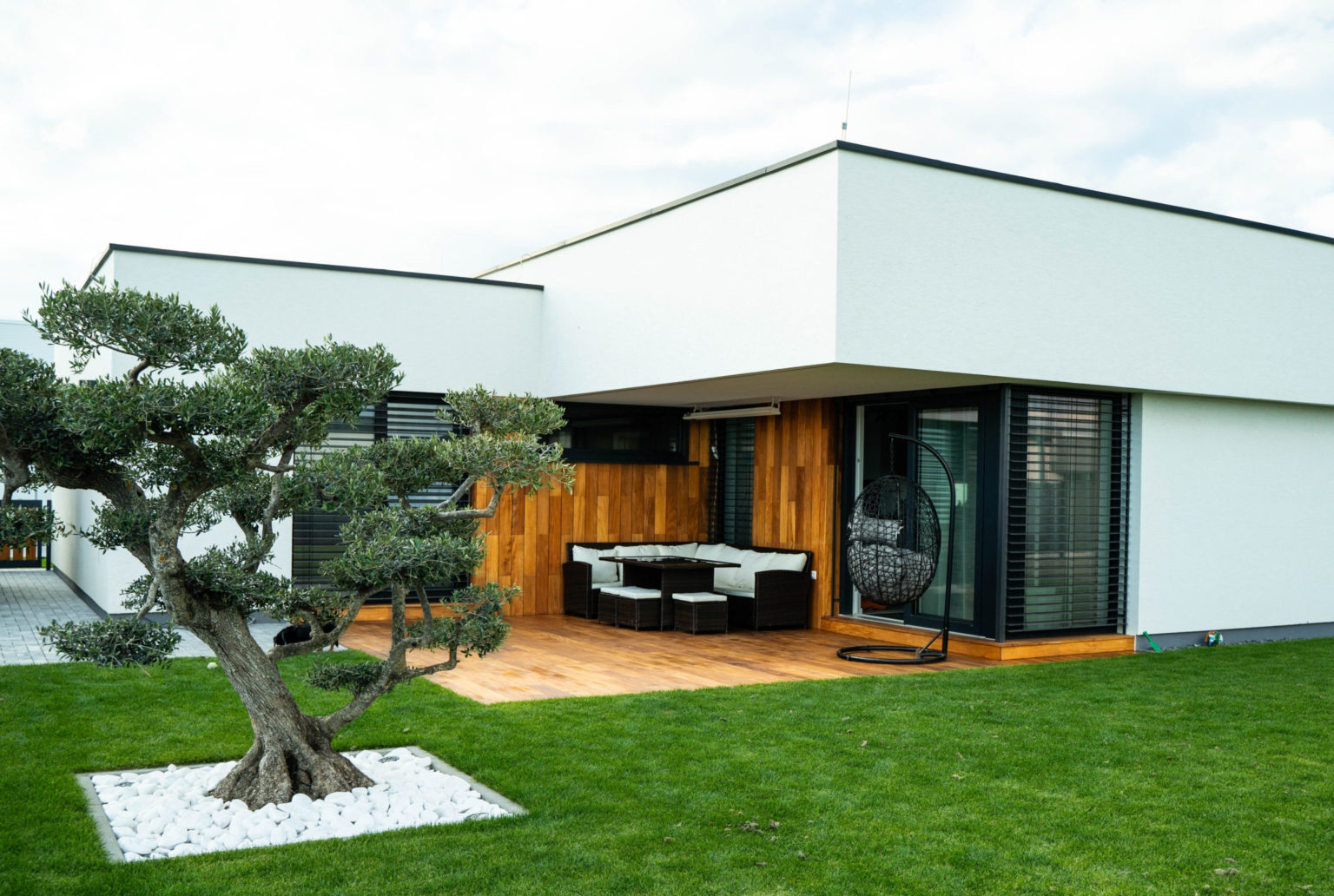 Moderný dom s drevenou terasou a fasádou